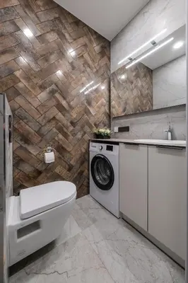 a bathroom with a toilet and a washer and dryer at Old Town - Bajor Studios - Self Check-in and Parking in Kaunas