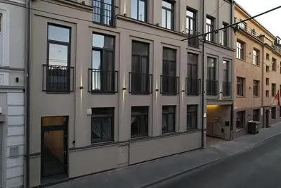 a building with windows on the side of a street at Old Town - Bajor Studios - Self Check-in and Parking in Kaunas