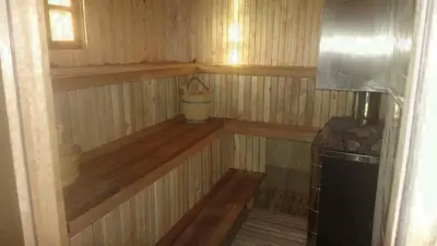 a inside of a sauna with a bucket in it at Pirtis su kubilu ant ežero kranto Birvarelax in Kariotiškės