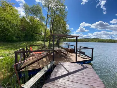 a dock on a body of water at Pirtis su kubilu ant ežero kranto Birvarelax in Kariotiškės