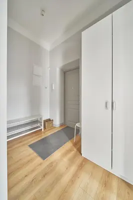 an empty room with white walls and a sliding door at Cute&Light Apartment, Vilnius City Centre in Vilnius