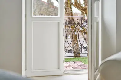an open door with a view of a yard at Cute&Light Apartment, Vilnius City Centre in Vilnius