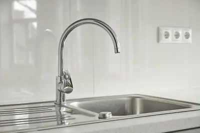 a kitchen sink with a chrome kitchen faucet at Cute&Light Apartment, Vilnius City Centre in Vilnius