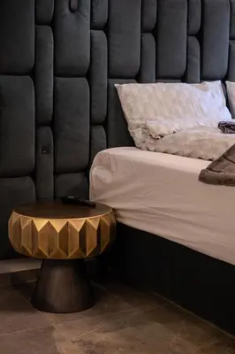 a bedroom with a bed with a table next to it at Old Town - Bajor Studios 2 - Self Check-in and Parking in Kaunas