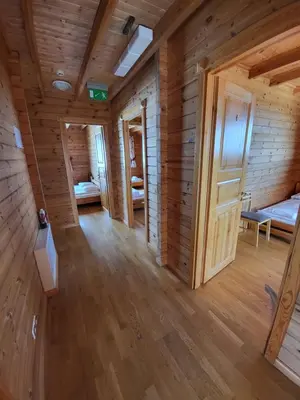 a large room with wooden walls and wooden floors at Vytauto kaimas - Didelis namas in Aukštadvaris