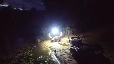 a group of people on a road at night at Mobilus namelis su jacuzi kubilu prie ezero Birvarelax in Kariotiškės