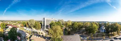 an aerial view of a city with a tall building at DRUSKININKŲ PANORAMA Apartamentai in Druskininkai
