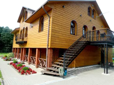 a building with a staircase on the side of it at Bražuolėje Pas Juozą- ramiam poilsiui in Trakai