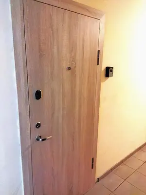 a wooden door in the corner of a room at Itaja apartment 49 in Šiauliai