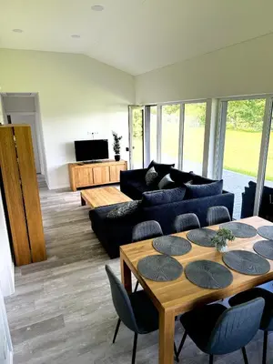 a living room with a couch and a table at Kaštonų krantas in Antotylʼtse