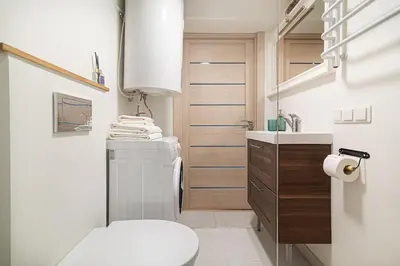 a small bathroom with a toilet and a sink at Lovely Loft in Old Town with free parking by URBAN RENT in Vilnius