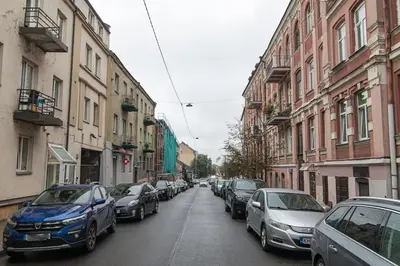 a street with cars parked on the sides of the road at Lovely Loft in Old Town with free parking by URBAN RENT in Vilnius
