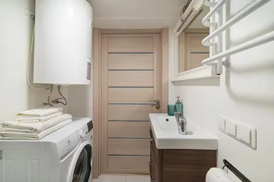 a laundry room with a washing machine and a sink at Lovely Loft in Old Town with free parking by URBAN RENT in Vilnius