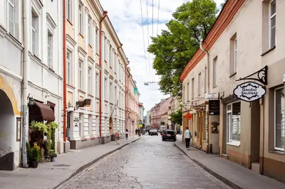 a cobblestone street in a city with buildings at Central and Comfy 2 Bedroom Apartment by Reside Baltic in Vilnius