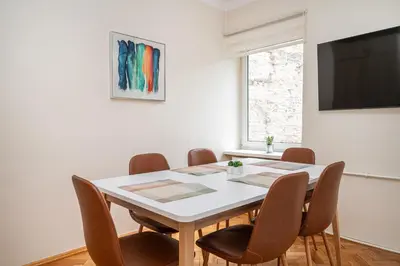 a dining room with a white table and chairs at Central and Comfy 2 Bedroom Apartment by Reside Baltic in Vilnius