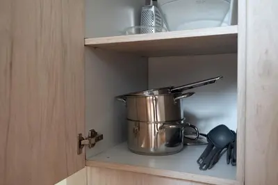 a pot on a shelf in a kitchen at Central and Comfy 2 Bedroom Apartment by Reside Baltic in Vilnius