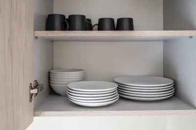 a shelf with plates and bowls on it at Central and Comfy 2 Bedroom Apartment by Reside Baltic in Vilnius