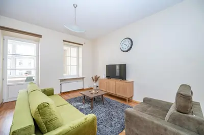a living room with a couch and a tv at Central and Lovely Apartment in Vilnius Old Town by Reside Baltic in Vilnius