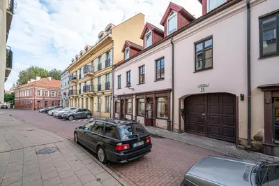 a black car parked on a street next to buildings at Central and Lovely Apartment in Vilnius Old Town by Reside Baltic in Vilnius