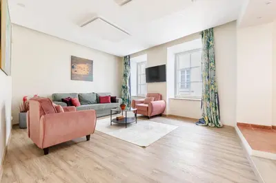 a living room with a couch and two chairs at Classic Apartments In The Prestigious Stikliu Str by Reside Baltic in Vilnius