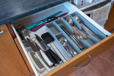a drawer filled with utensils in a kitchen at Classic Apartments In The Prestigious Stikliu Str by Reside Baltic in Vilnius
