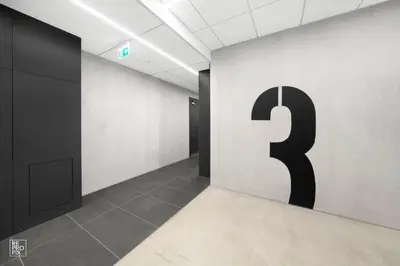 a hallway with a number three on the wall at Bright 2BR with Private EV Parking, workspace, AC in Kaunas