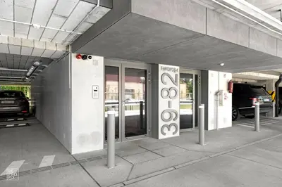 a parking garage with a car parked in it at Bright 2BR with Private EV Parking, workspace, AC in Kaunas