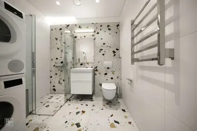 a white bathroom with a toilet and a shower at Bright 2BR with Private EV Parking, workspace, AC in Kaunas