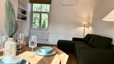 a living room with a couch and a table with wine glasses at City Center Appartment in Vilnius