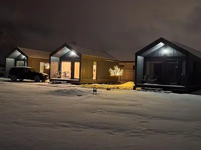 a row of houses in a parking lot at night at MiNi homes in Piniava