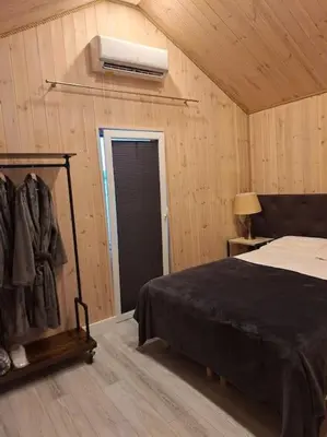 a bedroom with a bed and a air conditioner at MiNi homes in Piniava