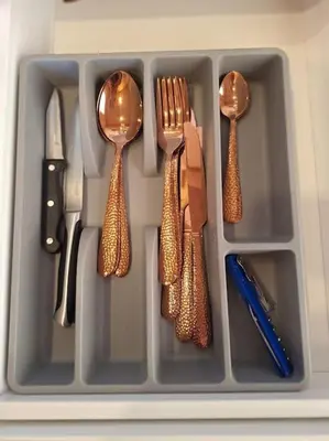 a plastic container with utensils in a utensil at MiNi homes in Piniava