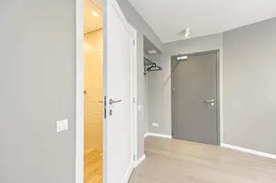 an empty hallway with a door leading to a closet at Asian Magnolia Express Studio Apartments in Druskininkai