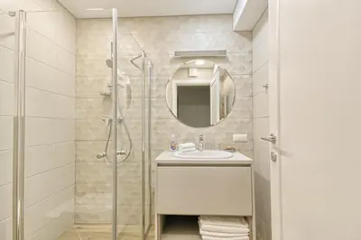 a bathroom with a sink and a shower at Asian Magnolia Express Studio Apartments in Druskininkai