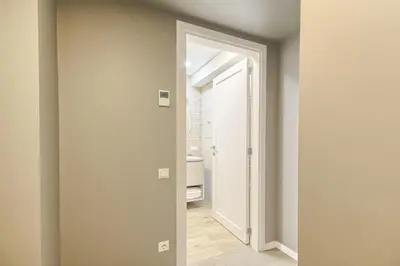 a hallway with a door leading to a bathroom at Asian Magnolia Express Studio Apartments in Druskininkai