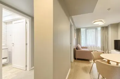 a living room with a table and a couch at Asian Magnolia Express Studio Apartments in Druskininkai