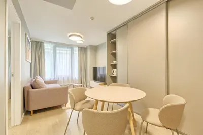 a living room with a table and chairs at Asian Magnolia Express Studio Apartments in Druskininkai