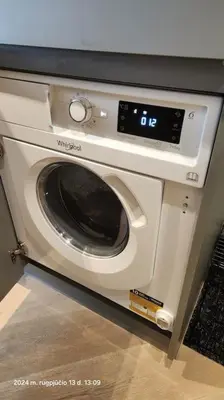 a washing machine in a cabinet in a kitchen at HaPPy Inn Exclusive studio, Self check in, Parking in Vilnius