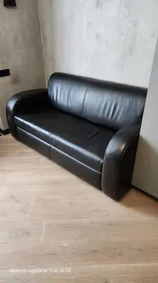a black leather couch sitting in a room at HaPPy Inn Exclusive studio, Self check in, Parking in Vilnius