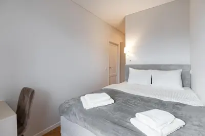 a bedroom with a bed with two towels on it at Stylish Simplicity - 1BDR Cozy Stay in Vilnius in Kontverki