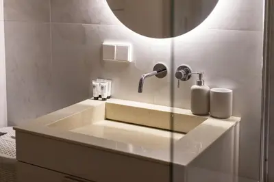 a bathroom with a sink with a faucet at Stylish Simplicity - 1BDR Cozy Stay in Vilnius in Kontverki