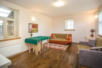 a living room with a table and a couch at Small House in Trakai Oldtown 1-6 sleeping places in Trakai
