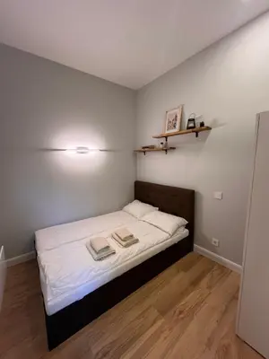 a small bedroom with a bed with two towels on it at Bastion Apartment Old Town in Vilnius