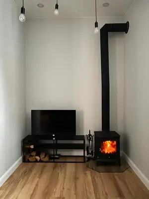 a living room with a fireplace and a tv at Bastion Apartment Old Town in Vilnius
