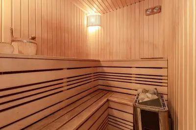 a wooden sauna with a trash can in it at Margirio namas in Birštonas