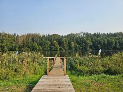 a wooden bridge over a body of water at Margirio namas in Birštonas