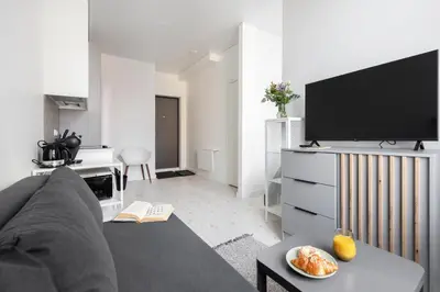 a living room with a couch and a flat screen tv at The K1A Studio Collective in Vilnius