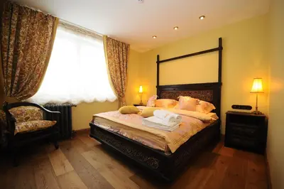 a bedroom with a large bed and a window at Argo Trakai in Trakai