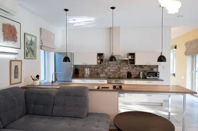a kitchen with two chairs and a table in a room at Vila Pušyno 4 in Kulautuva
