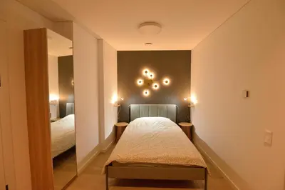 a small room with a bed and a mirror at Vilnius Old Town in Vilnius